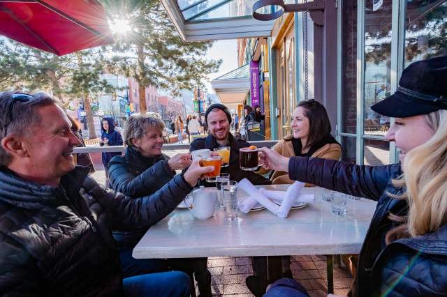 Family cheers on Pearl Street Patio in winter