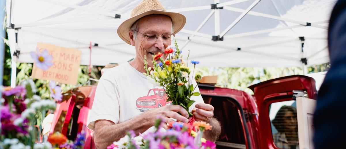 Boulder Farmers Market Man with flowers