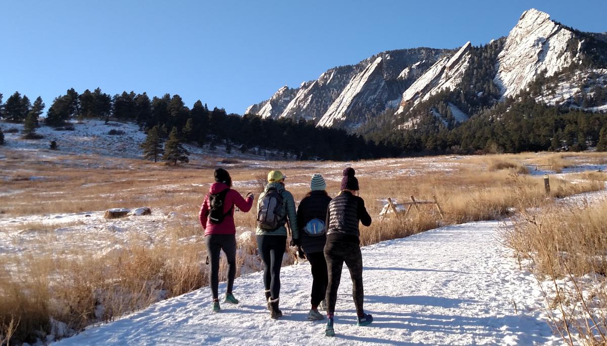 Wintertime hiking group in Flatirons in Boulder, CO
