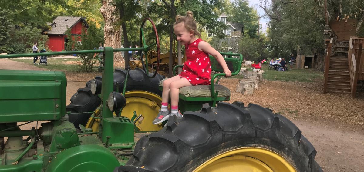 A child enjoys sitting on a tractor at Sunflower Farms outside of Boulder.